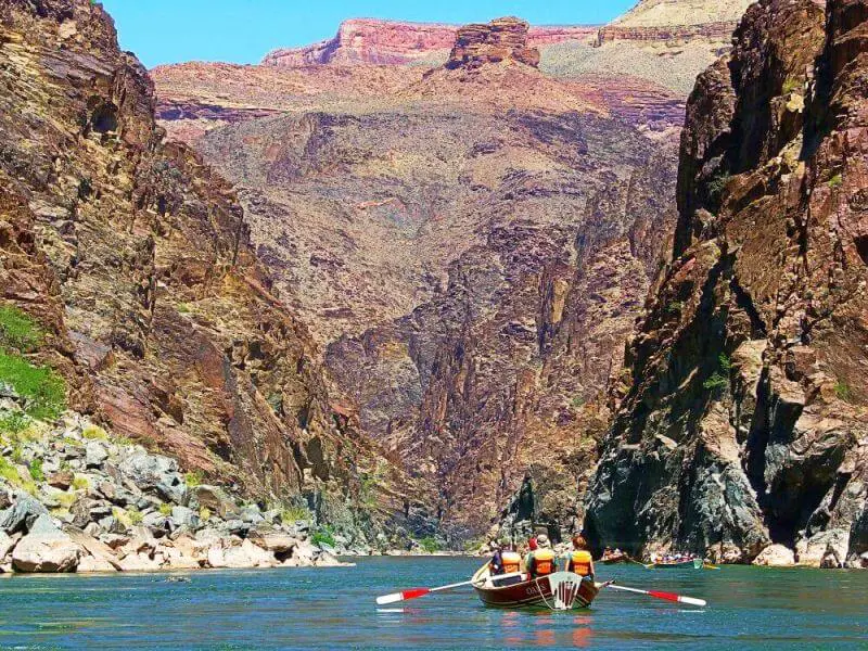 small wooden boats and oars inside grand canyon on river rafting trip through grand canyon