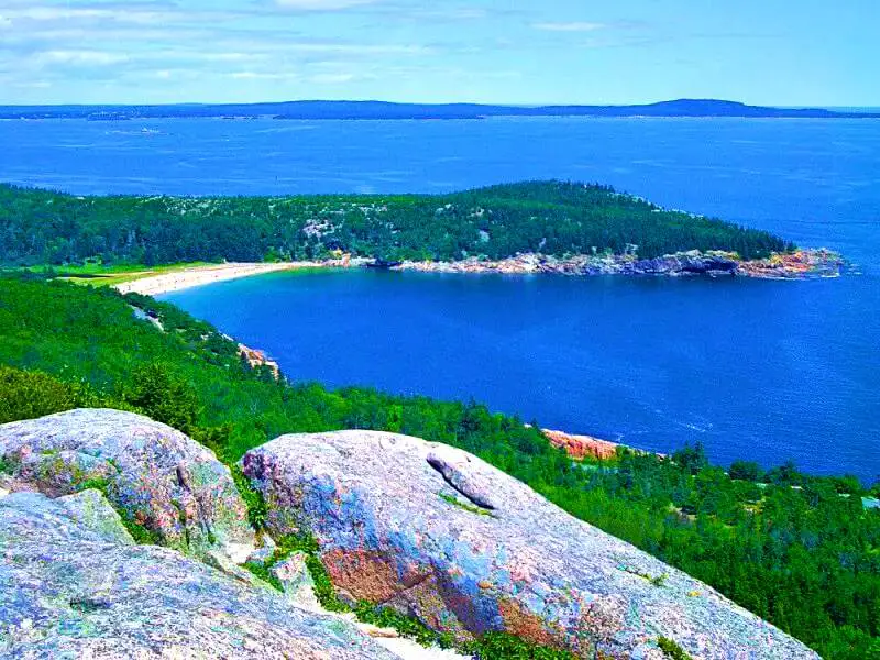 Aerial view of an ocean, island and trees in Acadia National Park.