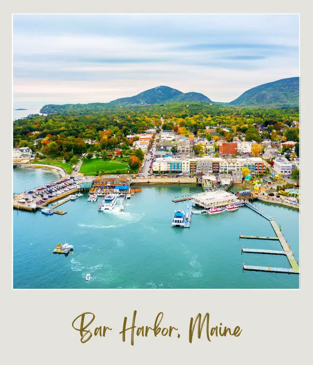 aerial view of bar harbor and mountains of Acadia National Park behind - places you will see in a tour of Acadia National Park