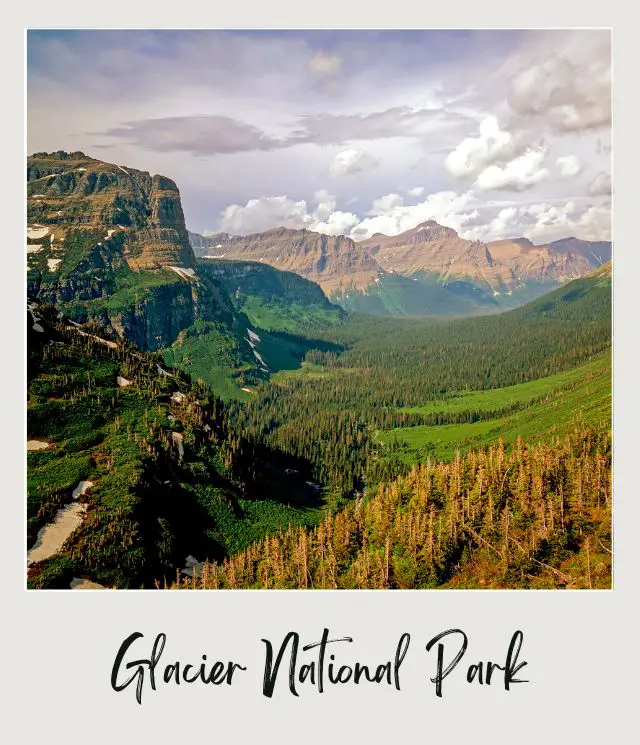 Aerial view of mountains, waterfalls, and trees in Glacier National Park.