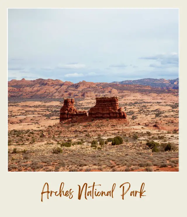 Aerial view of rock formations and bushes in Arches National Park.