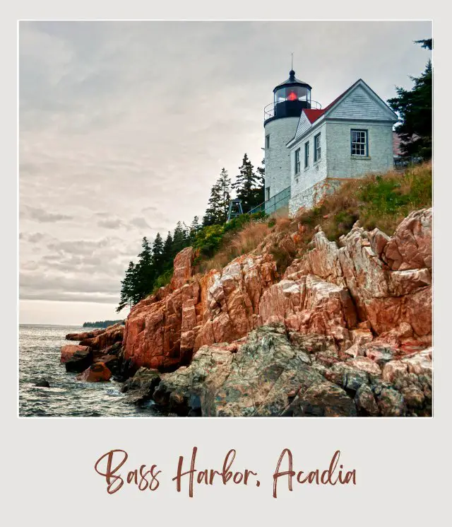 Red roof lighthouse near an ocean cliff in Bass Harbor Head Lighthouse Acadia.