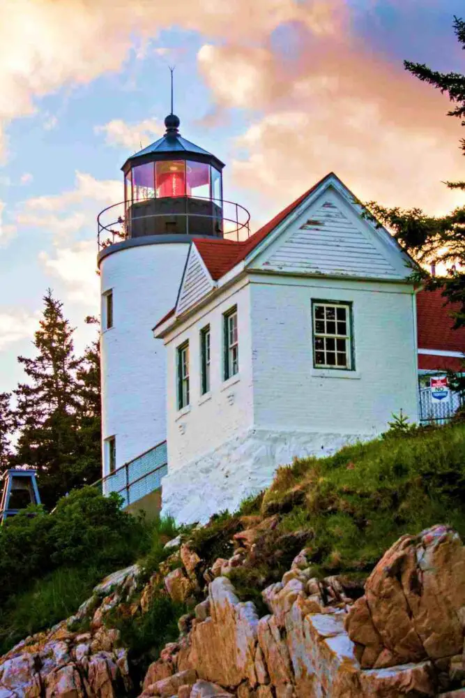 while lighthouse with red light - Bass Harbor Head Lighthouse in Acadia National Park