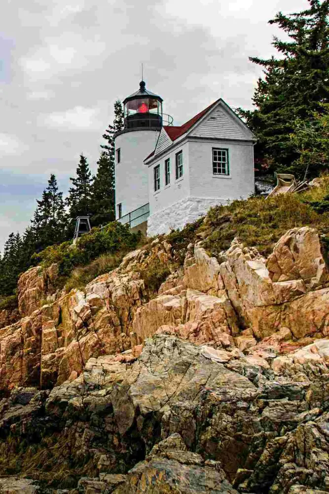 rocks and at top Bass Harbor Head Lighthouse in Acadia National Park