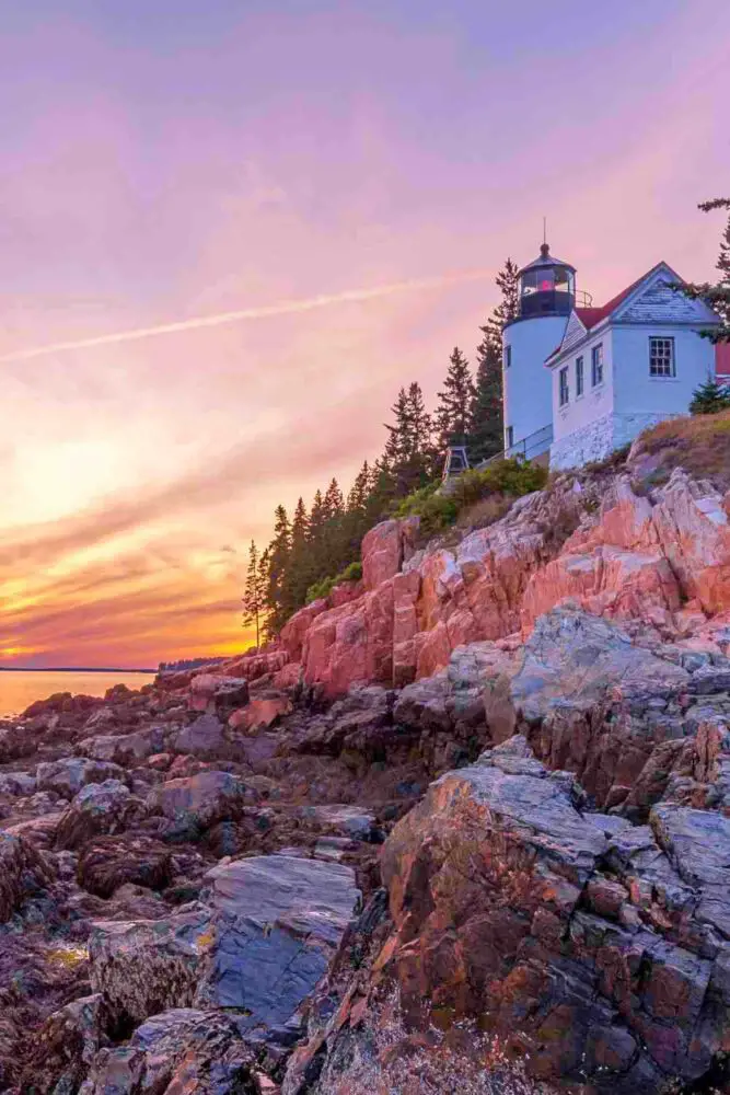 pink rocks at sunset with Bass Harbor Head Lighthouse in Acadia National Park