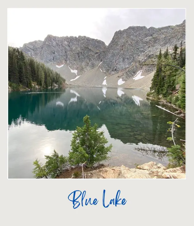 10 Fun Facts About North Cascades National Park View of the blue lake surrounded by trees and mountains in North Cascades National Park.