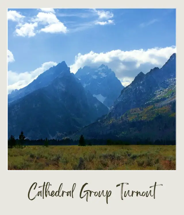 Mountains surrounded by clouds and trees in Grand Teton National Park.