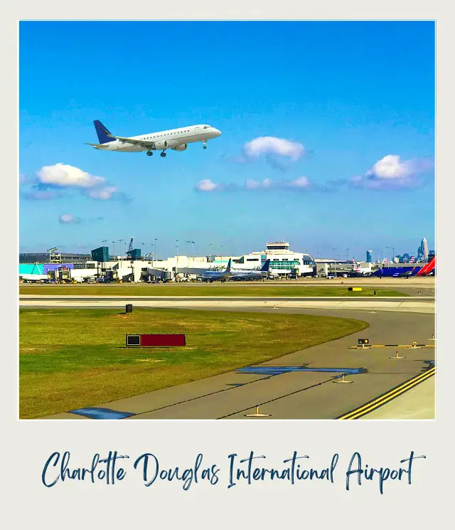 Green grass in the middle of the runway and an Airplane departing from Charlotte Douglas International Airport in the middle of the day