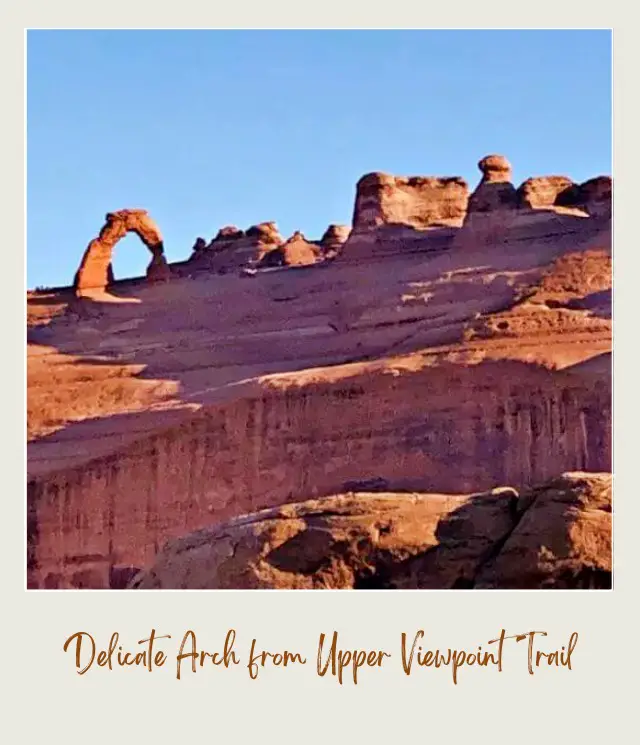 View of rock mountains and formations from below in Arches National Park.