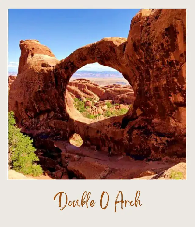 View of Double arch and behind are huge rock formations on Devils Garden Trail in Arches National Park.