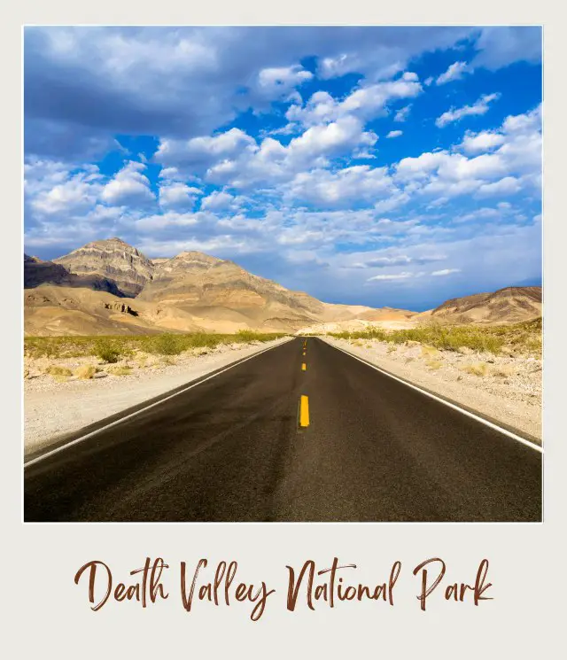 A straight road with a yellow line in the middle surrounded by small rocks and bushes, and on the other side are mountains under the blue sky in Death Valley National Park.