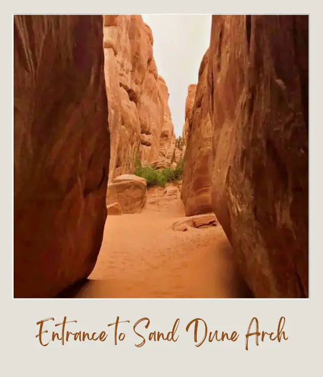 View of the narrow trail between two huge rock formations in Arches National Park.