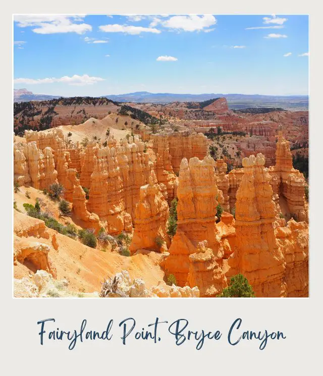 View of hoodoos surrounded by trees under the blue sky in Bryce Canyon National Park.