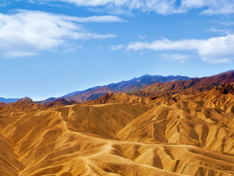 Mountain ranges under the blue sky in Death Valley National Park.
