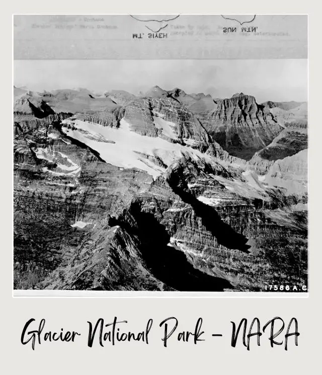 Black and white image of mountains covered with snow in Montana Glacier National Park.