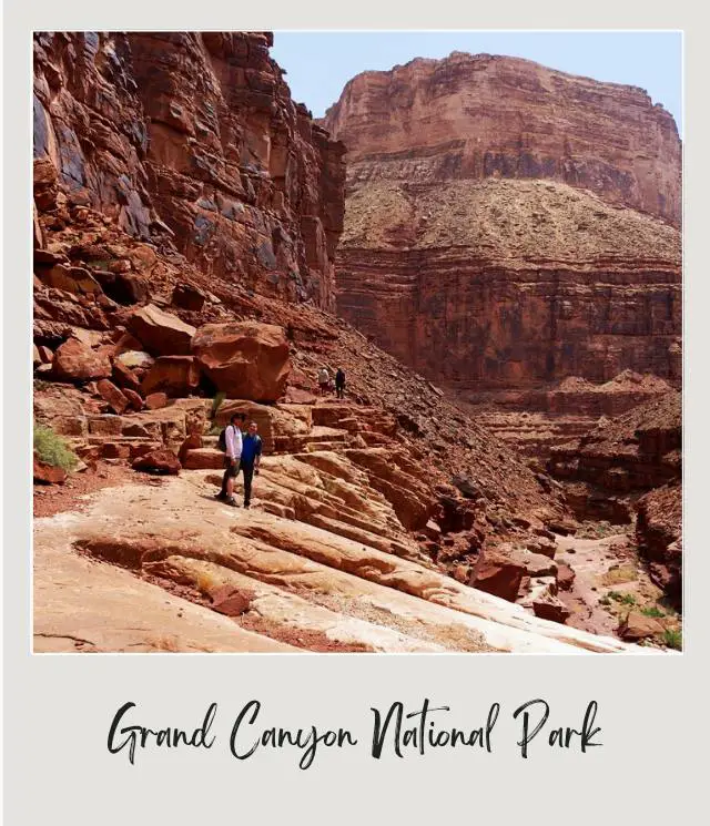 two people surrounded by grand canyon on river rafting trip through Grand Canyon