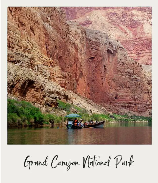 wooden boat with umbrella on calm river in large canyon on river trip through grand canyon