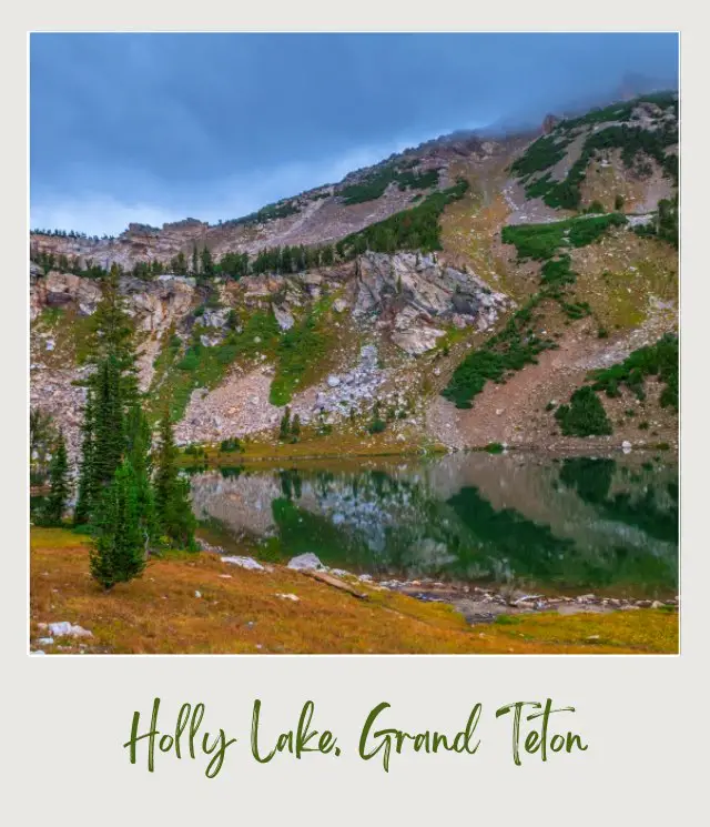 Lake surrounded by trees and mountains in Grand Teton National Park.