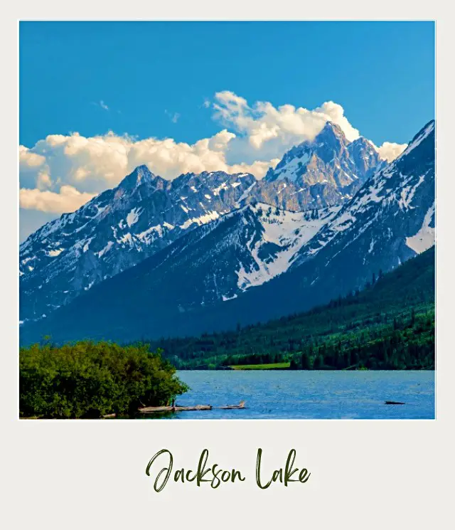 View of a lake and snow-capped mountains on cloudy day in Grand Teton National Park