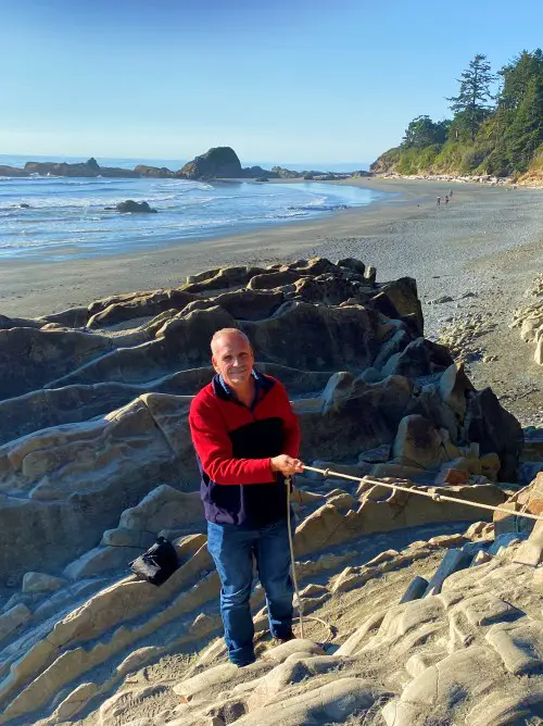 Man holding rope with beach in background at Kalaloch Beach 4 in Olympic National Park