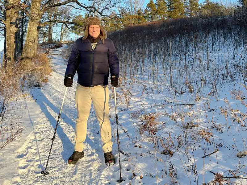 man standing on snow ground outside holding Leki Jannu Trekking Poles