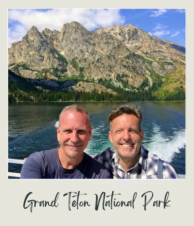 James and Kevin in Grand Teton National Park with a lake and mountains in the background.