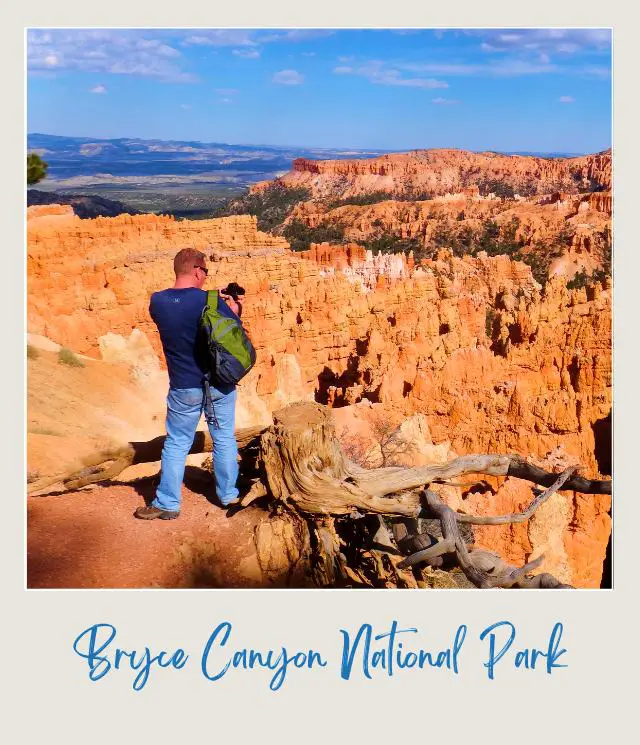 James holdong a camera standing on the mountains of hoodoos in Bryce Canyon National Park.