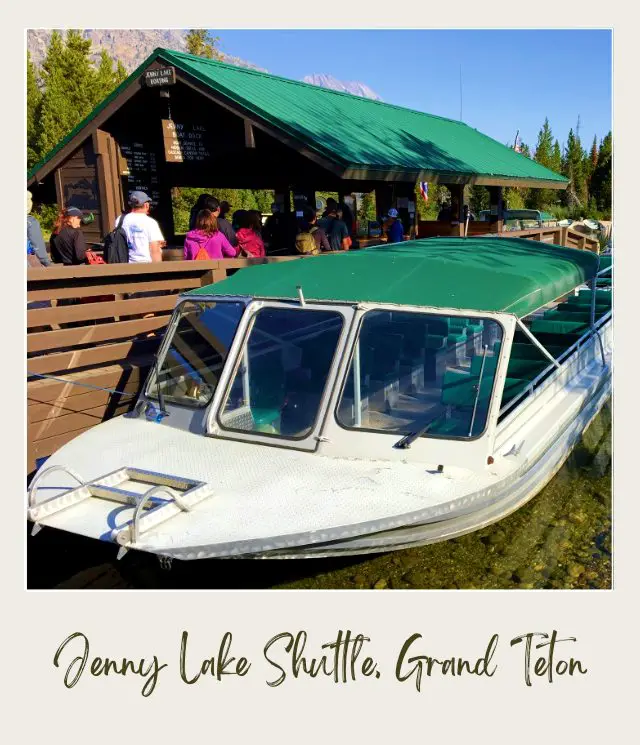 Shuttles on the lake and beside a building filled with people in Grand Teton National Park.