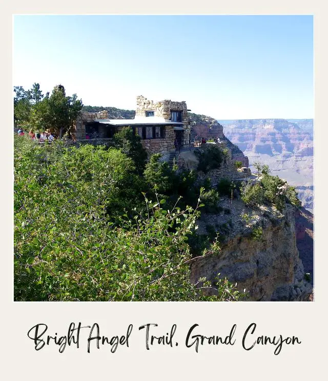 Kolb Studio in Grand Canyon National Park beside the cliff of the rocky mountain surrounded by trees, and bushes.