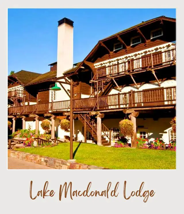 Historic three-story lodge with flowers and grasses in Lake Macdonald Lodge in Glacier National Park.