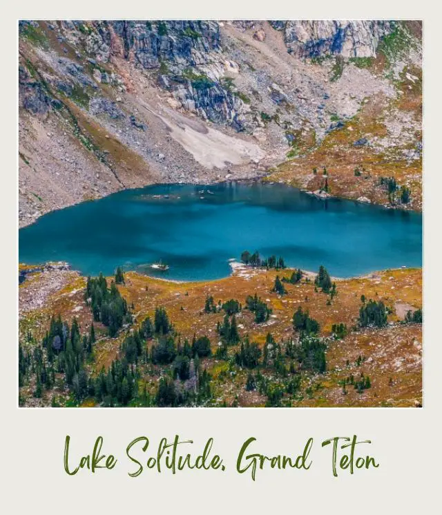 A blue lake surrounded by mountains and trees in Grand Teton National Park.