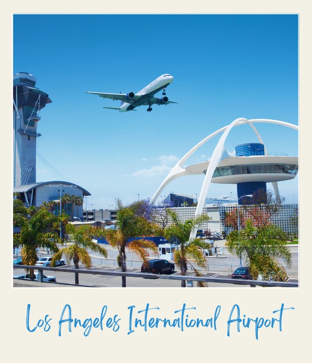 An airplane over tall buildings and a parking lot beside cars and trees surrounding Los Angeles International Airport.