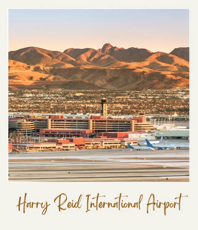 Mountains behind McCarran / Harry Reid Airport Las Vegas and at the forehand buildings are surrounded by trees beside the roads with several cars