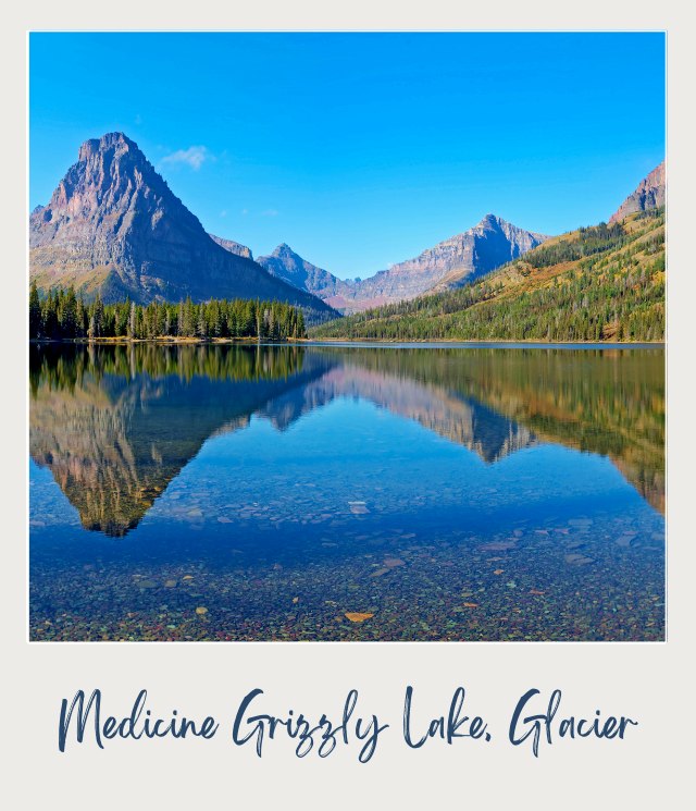 View of a lake and mountains surrounded by trees in the background in   Medicine Grizzly Lake, Glacier National Park