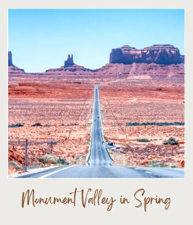 Visiting Monument Valley: What To Expect Throughout the Year View of a concrete and straight road along the fields with bushes and going to huge rock mountains in Monument Valley.