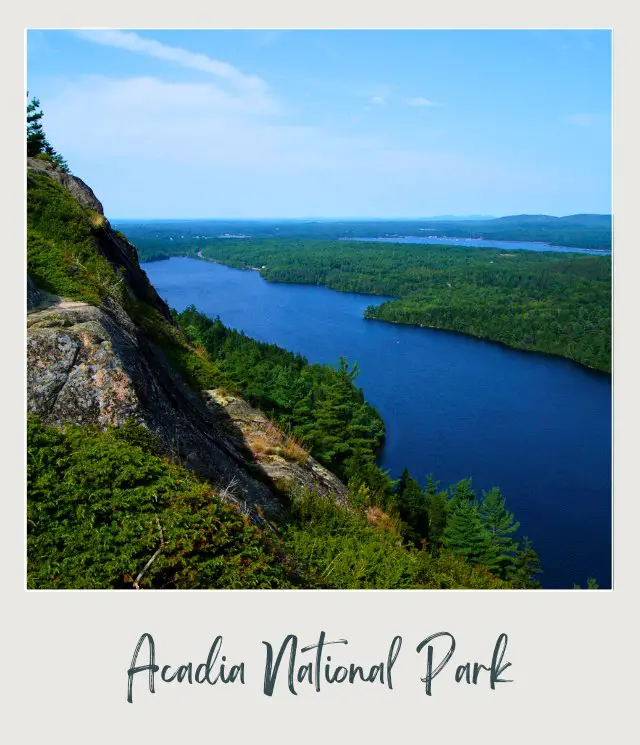 View of the lake along the forest and mountains in Acadia National Park.