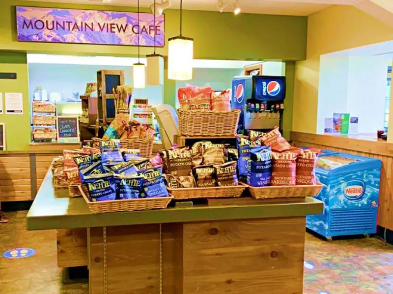 Snack foods are on the table, and behind are the freezer and soft drinks vending machine and other food container stuff in Mountain View Cafe Hurricane Ridge Olympic National Park