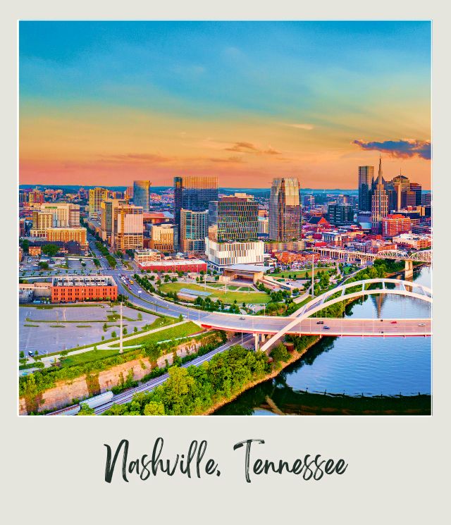 Trees surround long bridges across the river, and besides are buildings in the middle of the daytime in Nashville Tennessee