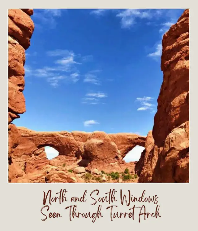 View of North and South Windows through turret arch in Arches National Park.