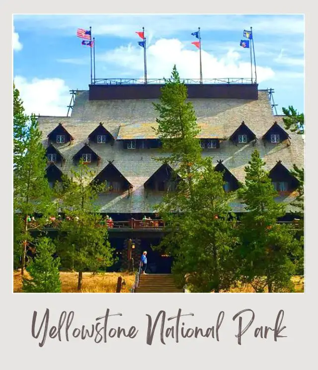 10 Fun Facts about Yellowstone National Park A huge building with flags on top of it and surrounded by trees in Yellowstone National Park