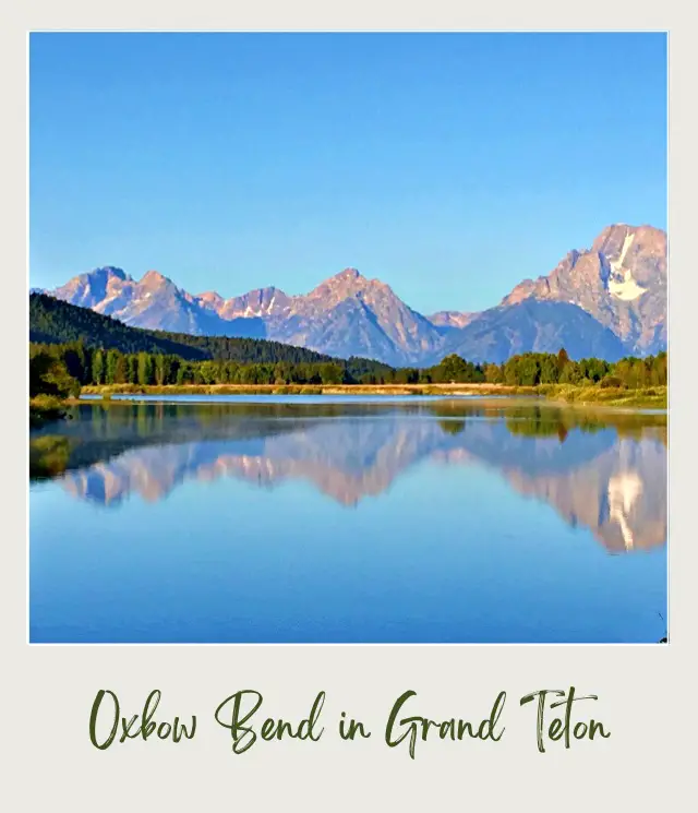 Lake with the reflection of mountains and trees in Grand Teton National Park.