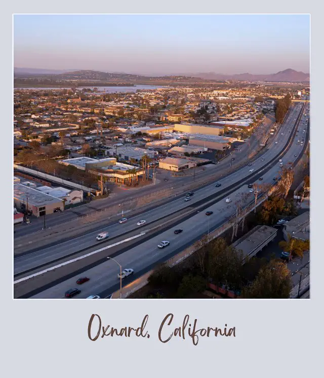 Aerial view of buildings, highways, cars and trees in Oxnard California Near Oxnard Airport.