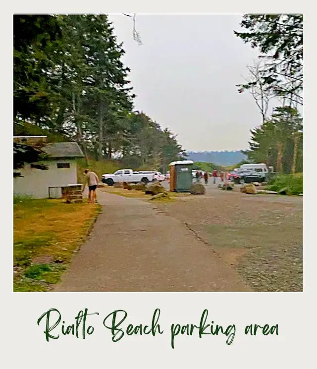 Rialto Beach - Hole in the Wall, Olympic National Park: Complete Guide End road at Rialto Beach, Olympic National Park with people on the road and beside are cars parked surrounded by trees and small buildings.