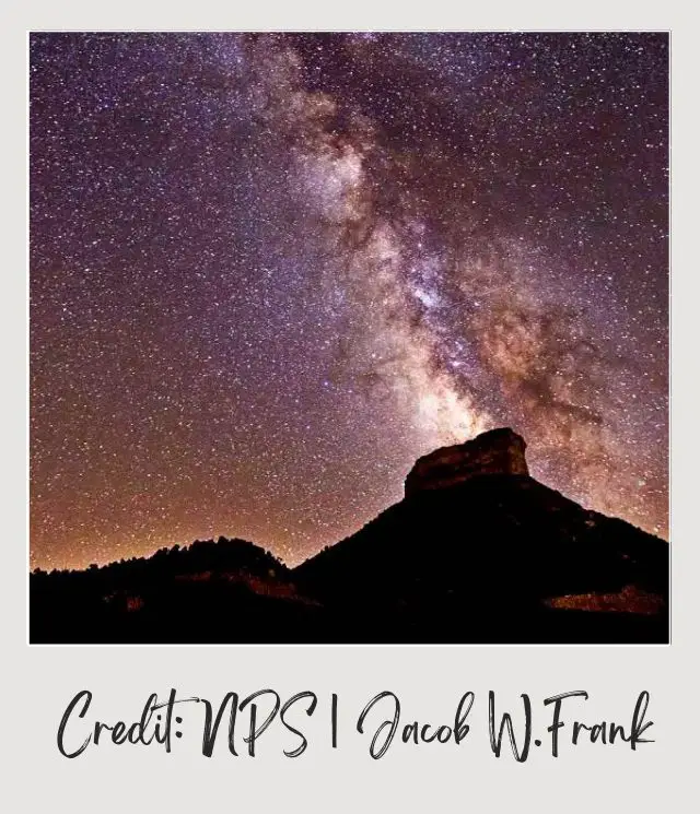 Rock mountains under the nights filled with stars in the nighttime in Mesa Verde National Park.