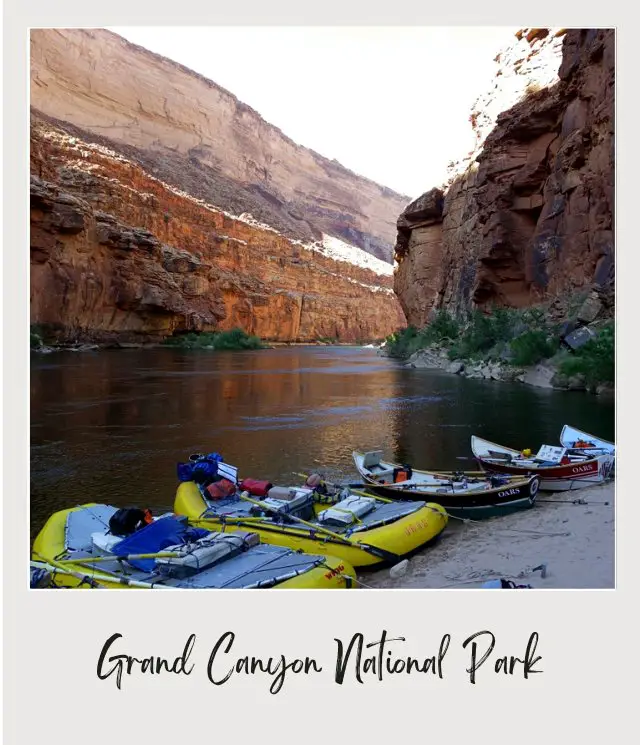 rafts and doreis pulled up on beach inside grand canyon on river rafting trip through grand canyon