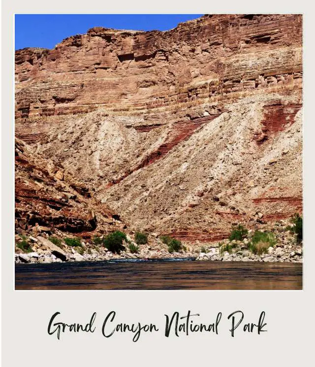 tiny boat surrounded by towering cliffs of grand canyon on river rafting trip through grand canyon