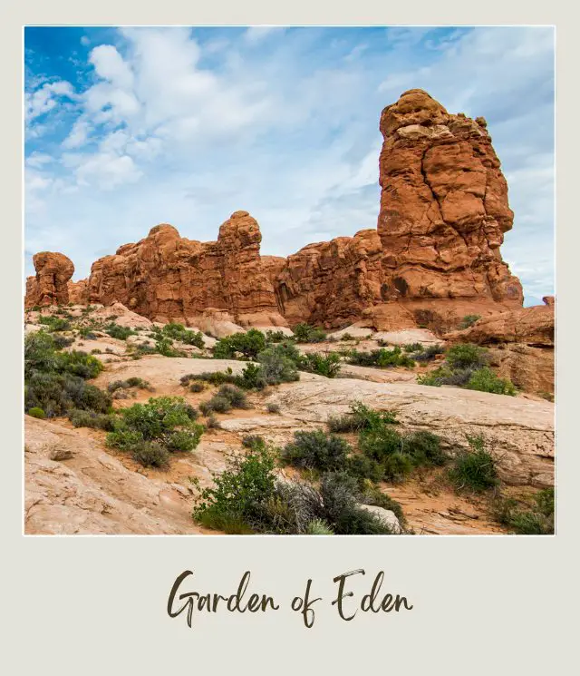 View of huge rock formations and below are bushes in Balance Rock in Arches National Park.