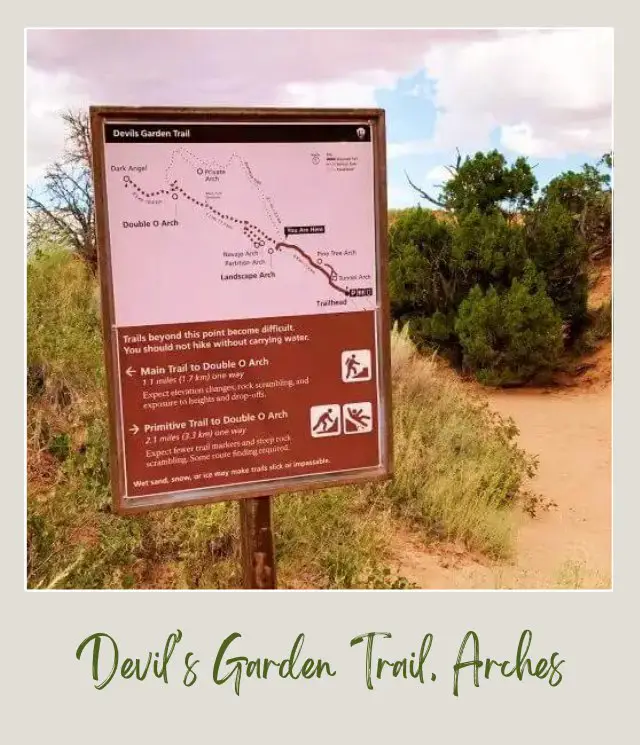 Huge signage on Devils Garden Trail and behind bushes on the trail in Arches National Park.