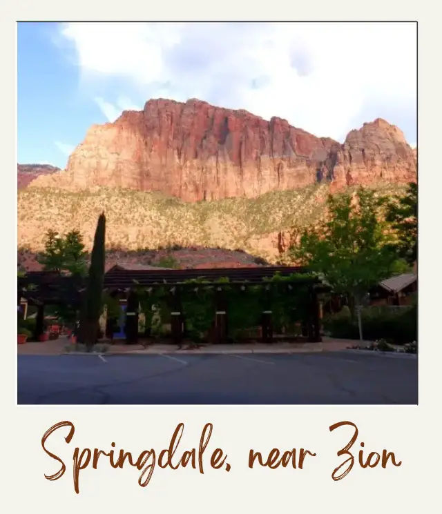 low buildings with cliffs behind in Springdale, just outside Zion National Park