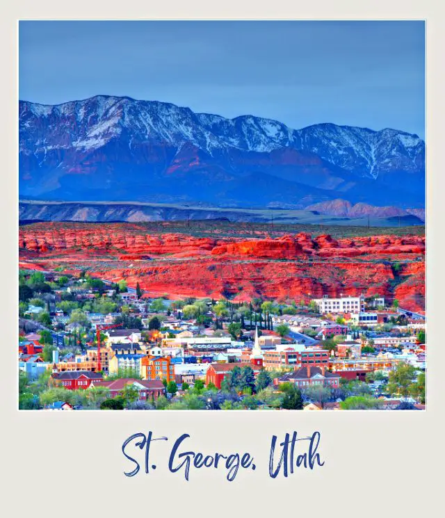 Buildings are surrounded by trees below brown hills in St. George, Utah